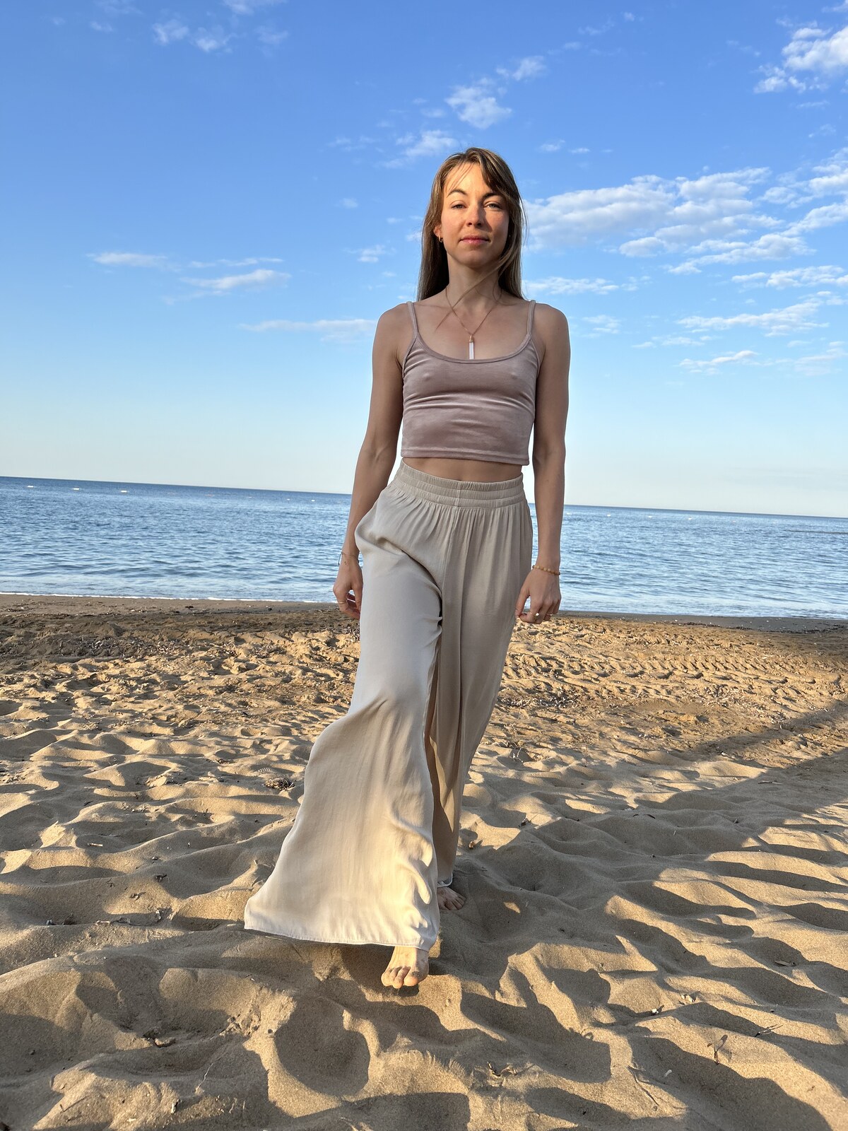 Portrait at the water's edge, hand on hip, soft sunset light